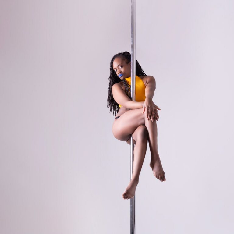 Woman on pole teaching how to discover pole class at London Dance Academy