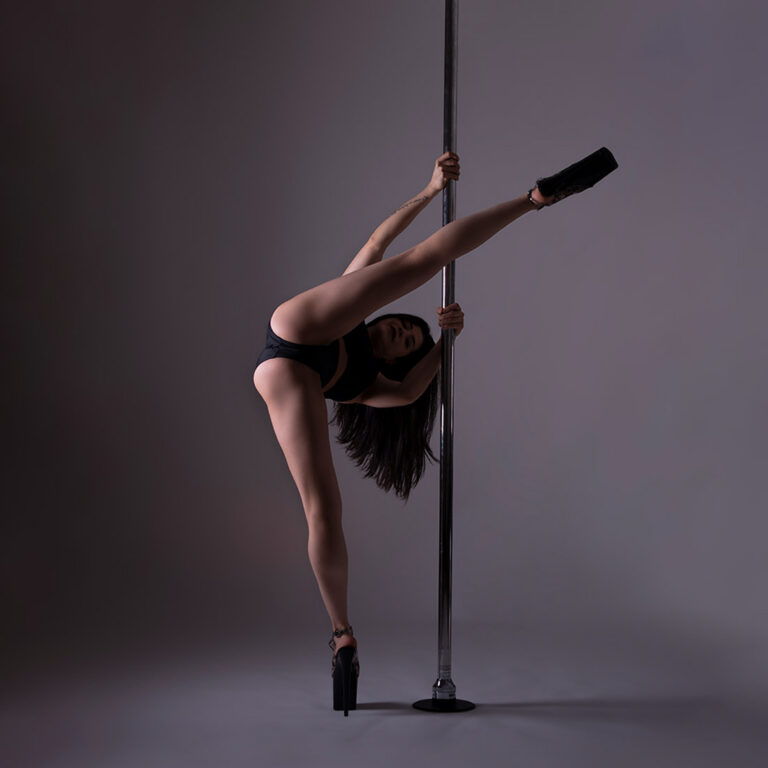 pole dancing teacher showing heels choreography move in class at london dance academy